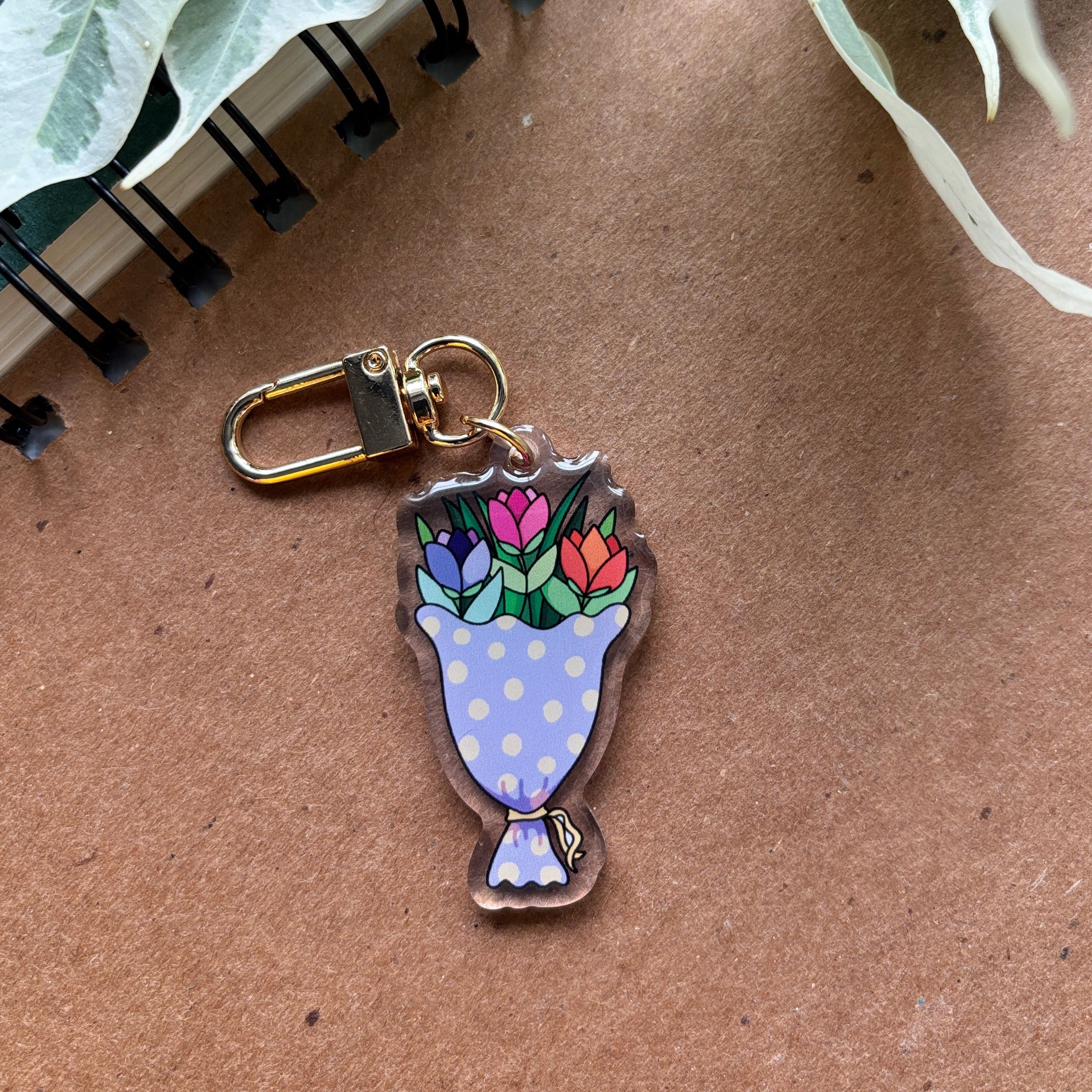 Keychain with floral design on a brown surface